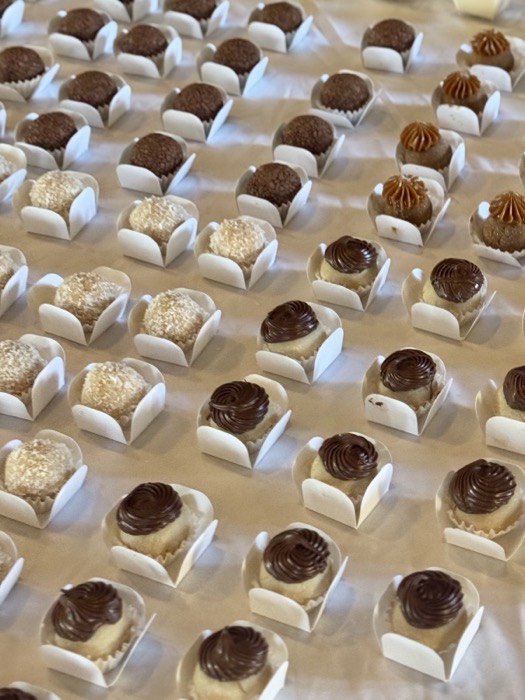 Rows of Brazilian brigadeiro truffles in white paper cups