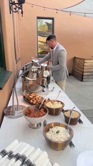Guests helping themselves at a styled catering buffet