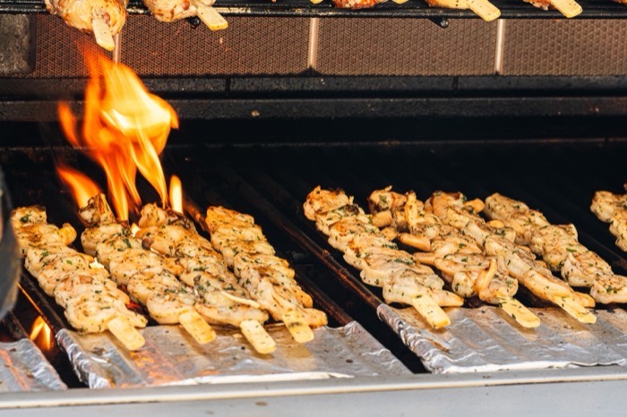 Garlic shrimp skewers grilling over an open flame