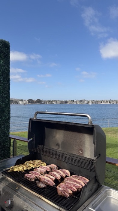 Churrasco grill loaded with picanha and chicken skewers overlooking Mission Bay