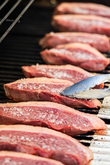 Row of trimmed prime sirloin cap picanha cuts prepared for grilling