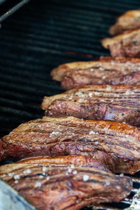 Close-up of picanha steaks seasoned with coarse salt before grilling
