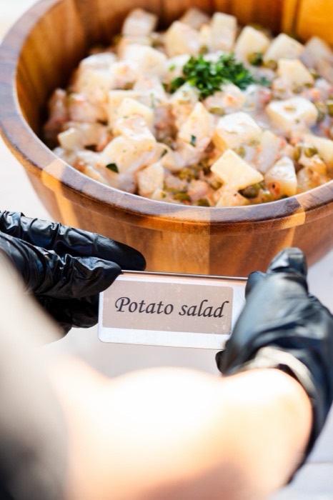 Creamy housemade potato salad served in a wooden bowl