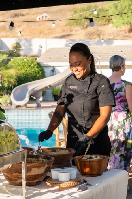 Stick'n'Bite team member grilling churrasco at a poolside event